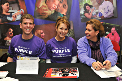 Three people at a booth